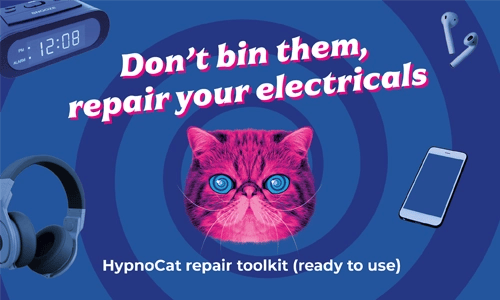 ‘HypnoCat’ (a magenta-coloured Persian cat with blue spiral eyes) leaning on a blue dustbin and electrical items floating in a blue spiral background with the words "don't bin them repair your electricals"