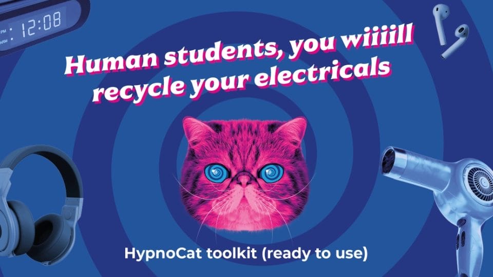 ‘HypnoCat’ (a magenta-coloured Persian cat with blue spiral eyes) in front of a blue spiral background with electrical items floating in the spiral. Text: Humans students of the UK - You will recycle your electricals