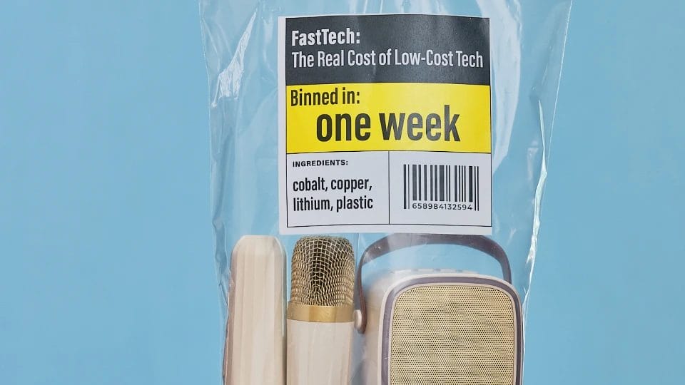 a pale skinned hand holding a clear plastic bag with some small microphones in with writing saying "one week" on it