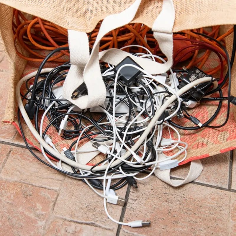 a cotton bag full of cables that has fallen over putting the cables onto the floor